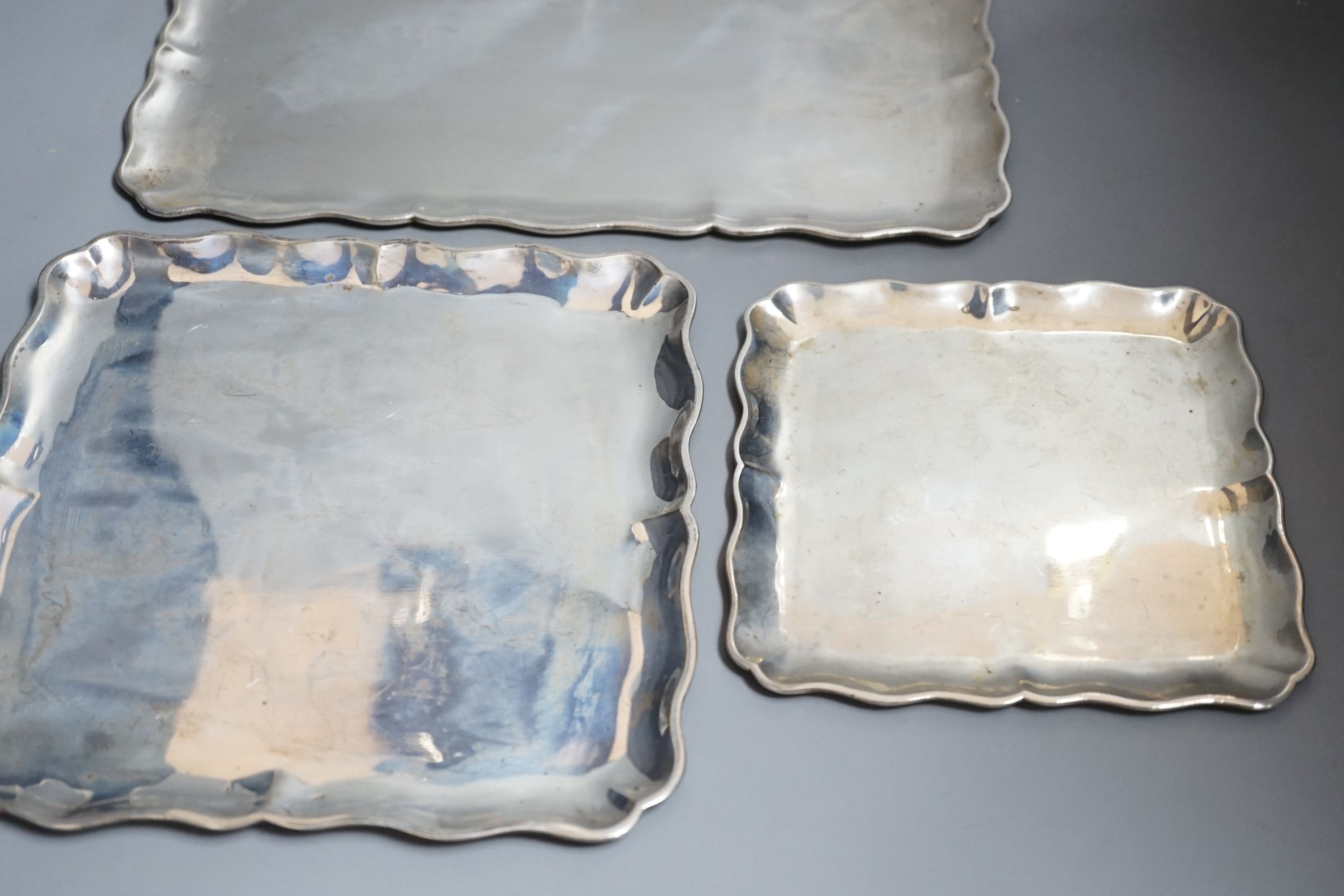 A graduated suite of three Austro-Hungarian white metal trays with wavy borders, largest 34.5cm, 36oz.